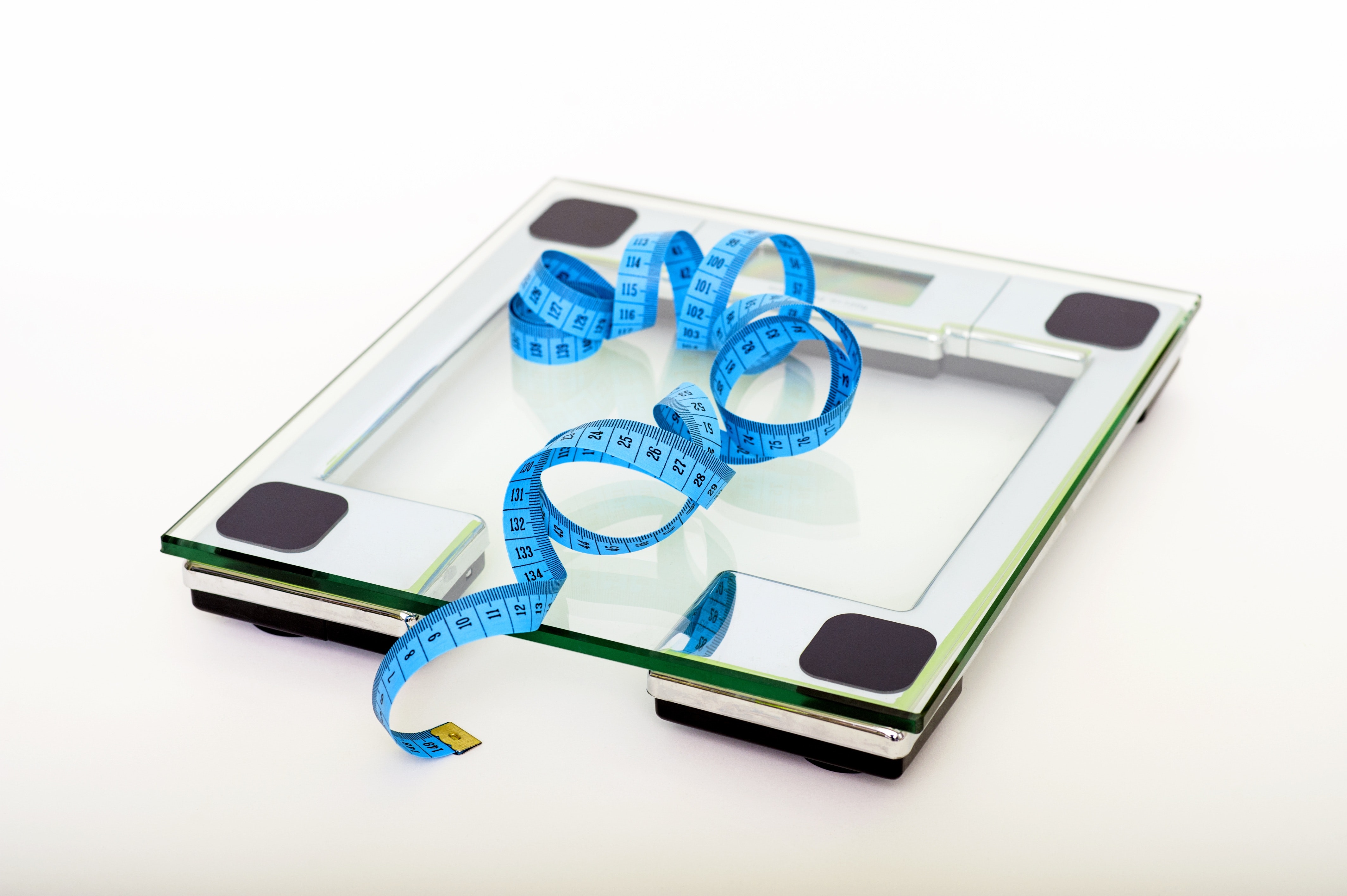 weight loss vs. fat loss measuring tape on top of scale