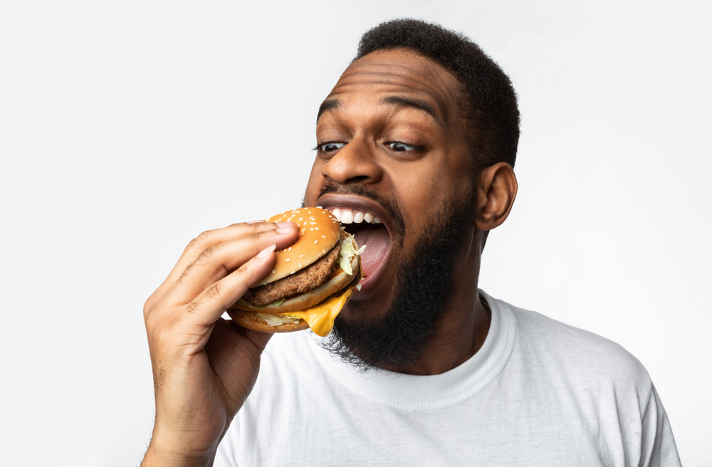 man eating a cheeseburger