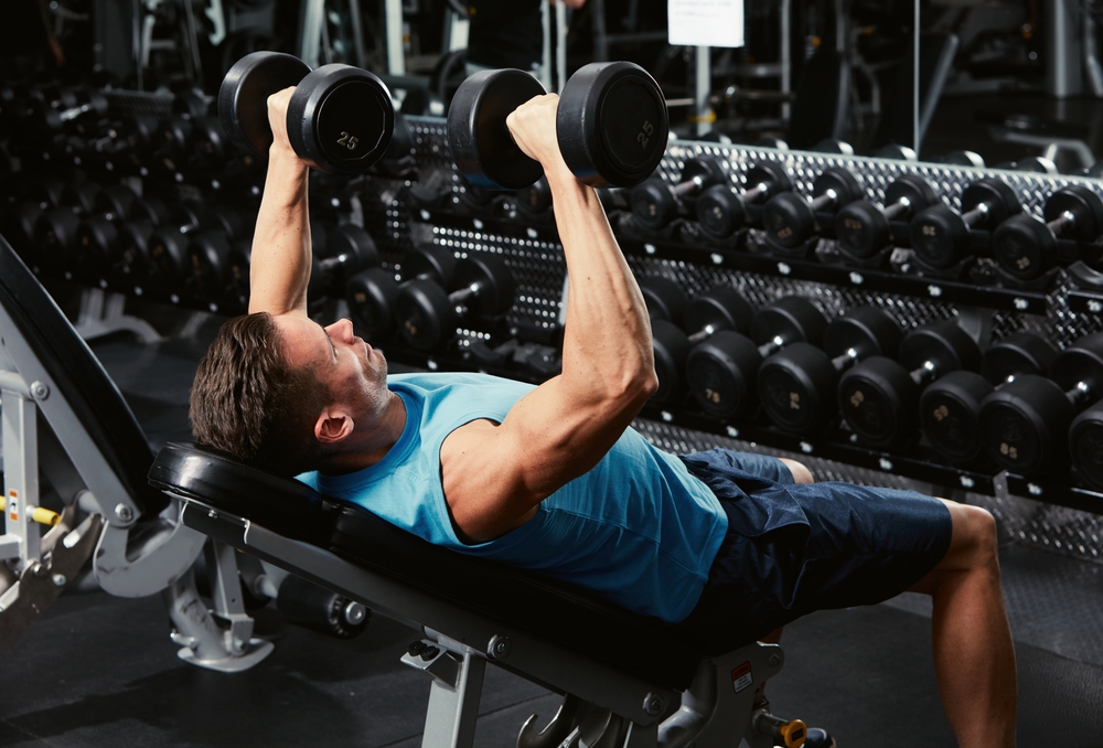 man performing dumbbell incline bench